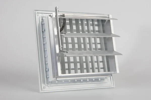 Components for climate technology. White filter for air conditioner. Ventilation grille on a white background. Maintenance of air conditioners. Creating a pleasant microclimate in the house.