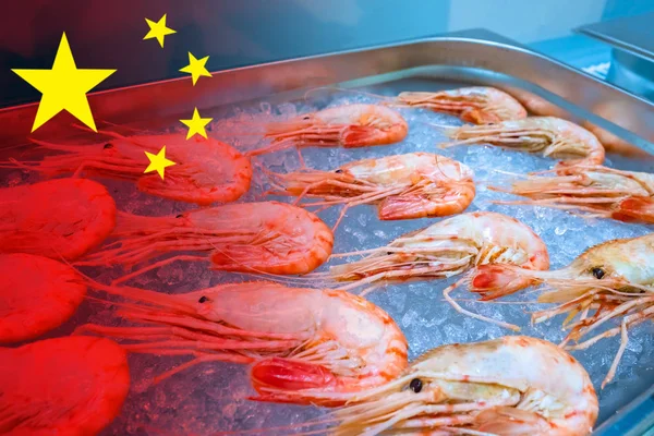 Chinese food industry. Fishing. Fish semi-finished products. Frozen shrimps on the background of the Chinese flag. Chinese fishing industry. Seafood supplies from China.