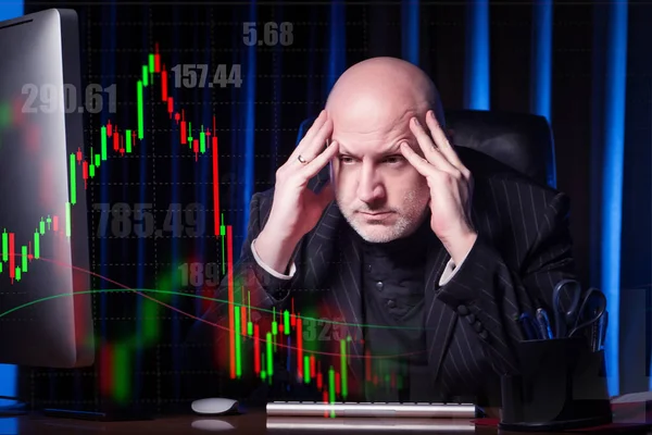 A tired man in a black suit against the background of stock quotes. Hard work on the stock exchange. The foreign exchange market. Securities market. Forex. Work of a professional stock broker.