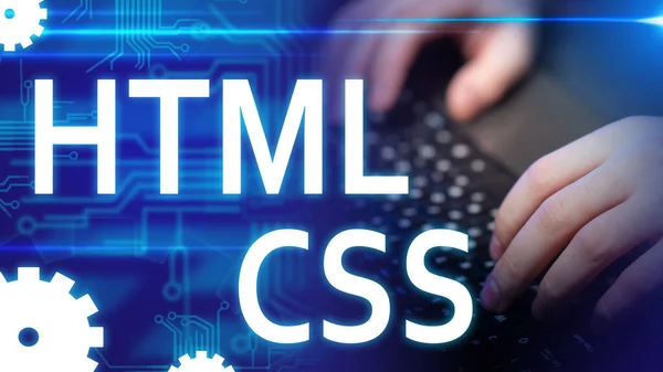 HTML. CSS. Logos of programming languages. Hands of a web master close ...