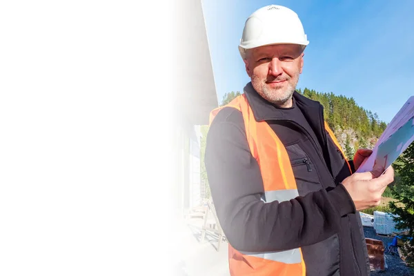 Builder with drawings in the hands. A man in construction clothing close-up. The team leader at the construction site is looking at Kemera. Place for text. Concept - work on the construction site.