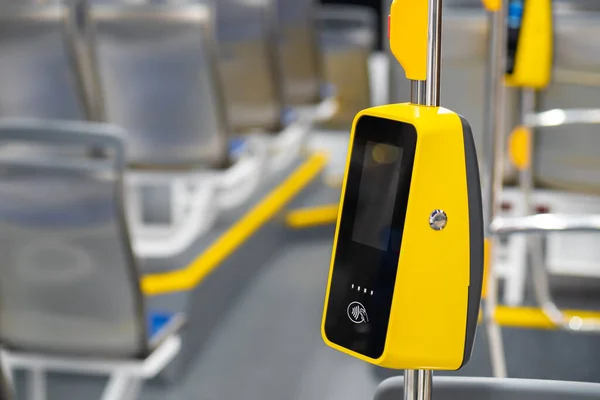 Contactless payment system on the bus. Payment for travel. Tram. Contactless payment in public transport. Card fare. The money receiving device hangs on the handrail. Equipment for public transport