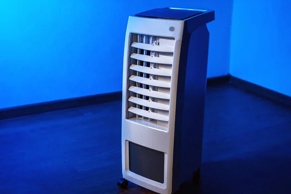 Air conditioning. Mobile air purifier with. Portable conditioner. Cleaning the air in the apartment. Temperature cooling in the room. Concept -  temperature reduction. Mobile air conditioning.