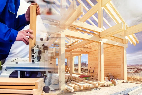 Construction of a cottage made of wood. Carpentry work on a construction site. Wood processing. Carpenter saws wood for building a house. Carpenter at work.