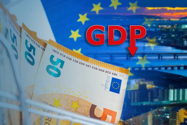 Inscription GDP near the night city. Economic situation in European Union. Money as a symbol of the economy. Euro Money close up. Reduction in GDP. Gross domestic product decline. Euro zone crisis