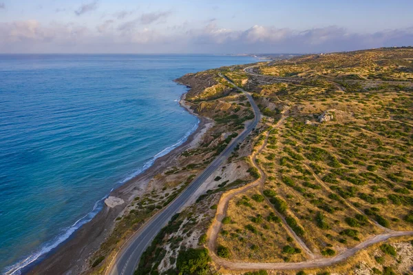 Mountain road. Mediterranean Sea. Road near the ocean. Highway in a picturesque place. Cyprus coast top view. Panorama of the Mediterranean coast. Coast of the ocean. Mountain path.