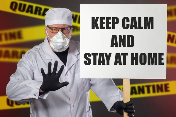Keep calm and stay at home. Virologist calls for staying home. Medic asks to stay calm. Call is at home on a banner. Doctor with a banner in his hands. Concept - call not to panic due to pandemic