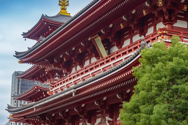 Japan. Asakusa in Tokyo. Buddhist pagoda near the temple. Tokyo in sunny weather. Sensoji Temple on a summer day. Buddhist temples on the background of a modern building. Japan tour.