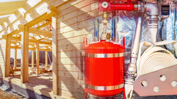 Fire extinguishing system in a building under construction. The cottage will be equipped with a fire protection system. Fire extinguishers in the new house.