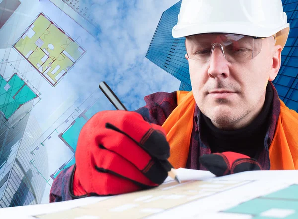 Civil engineer. A man in a hard hat on the background of buildings. The engineer makes notes in the construction documentation. A man in a reflective vest and work gloves.