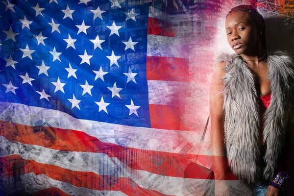 An African-American woman in a fur vest next to an American flag. A dark-skinned girl and the us flag on a colorful background. American model with braids.