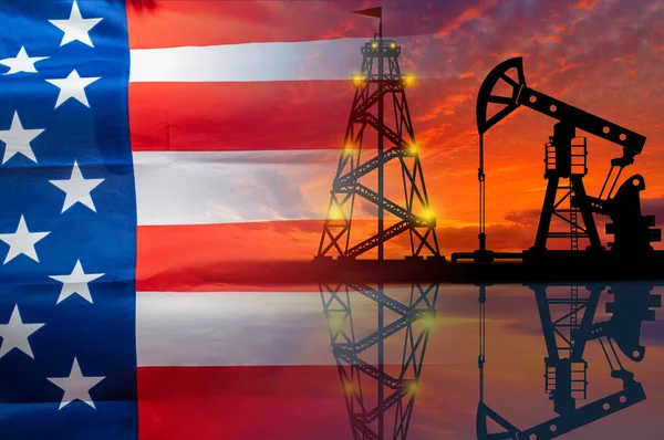 Oil production in the United States. Oil platform on the background of the American flag. American flag and oil rig. US fuel market. Natural resource extraction in America.