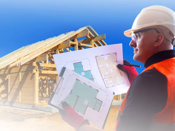 Builder is looking at work plan. Concept - construction business.  Adult man examines drawings house. Man works as a builder. Concept - architector career. Process of building a frame house. Outside