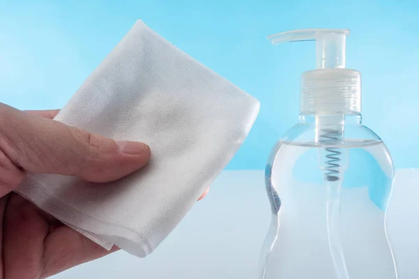The concept of cleanliness at home and at work. Sanitizer and cleaning cloth in the hands of a person. Elimination of viruses and bacteria.Fight against pathogens.Cleaning during the quarantine period
