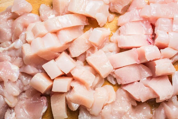 Sliced chicken fillets on wooden board. — Stock Photo, Image