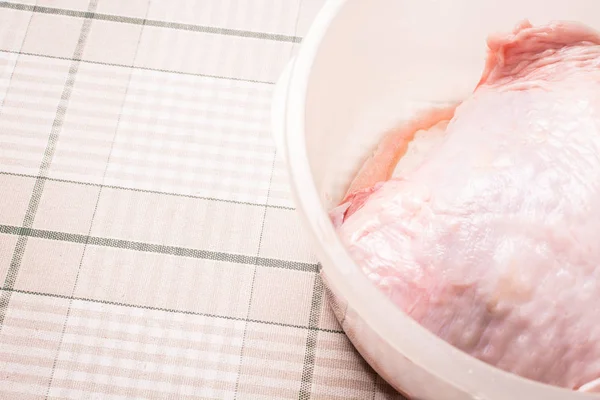Boneless raw turkey fillet in plastic egg on kitchen table. — Stock Photo, Image