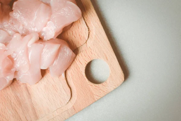 Sliced chicken fillets on wooden board. — Stock Photo, Image