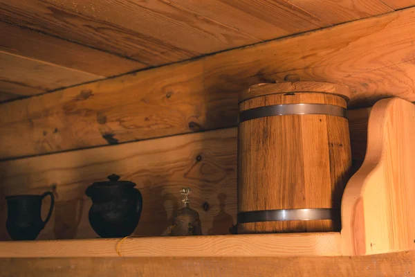 Wooden bucket on kitchen shelf for storing cereals and food