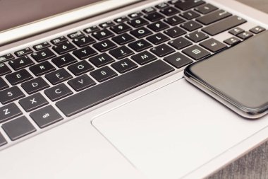 Evde uzaktan çalışma için dizüstü bilgisayarı olan cep telefonu