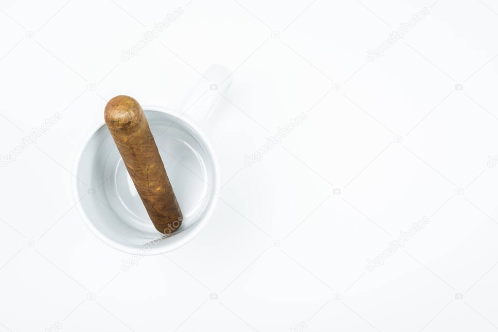 Gorgeous cigar from twisted sheets in mug with white background