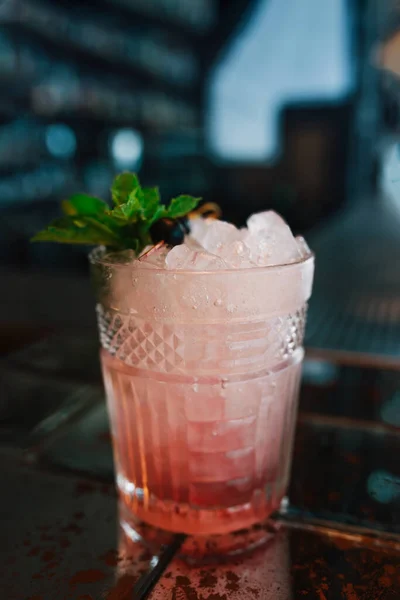 Alcoholic blueberry cocktail at bar background. Closeup.