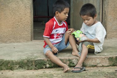 Bora boys play with toy after study in a school, Padre Cocha, Iquitos, Peru. clipart