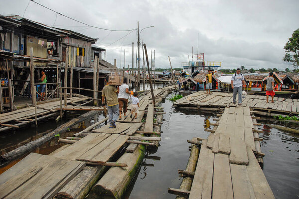 IQUITOS, PERU, APRIL 28, 2010: Public pier Nanay for small boats in Iquitos, Peru. Boats are only mode of transport to connect remote villages with Iquitos.