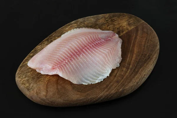 Filet Poisson Tilapia Sur Une Planche Fond Noir — Photo