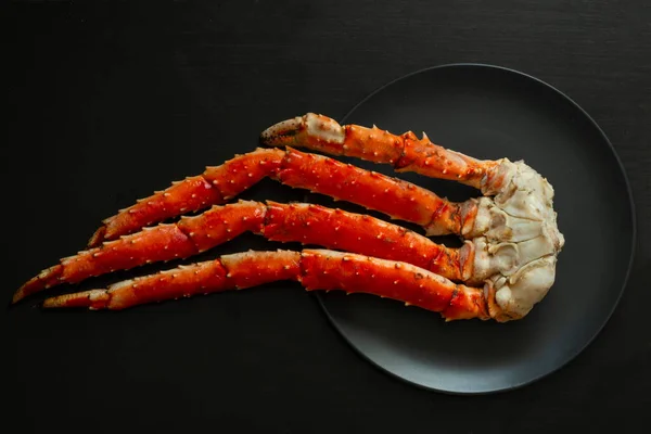 Baked kamchatka crab phalanges on a plate.