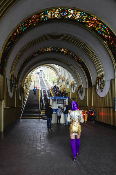 Kiev, Ukraine A woman dressed in flamboyant colors enters the Kiev funicular in Podil, a hip and working class section of town.