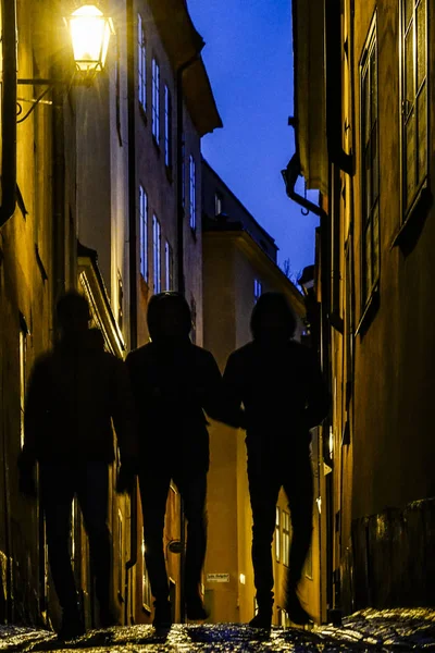 Stockholm, Sweden Three friends walking on Baggensgatan in the Old Town or Gamla Stan.