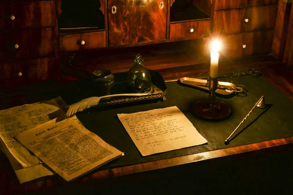 Stockholm, Sweden A desk with writing implements and a candle at the Skansen Museum to illustrate bourgeois life in the 1700s