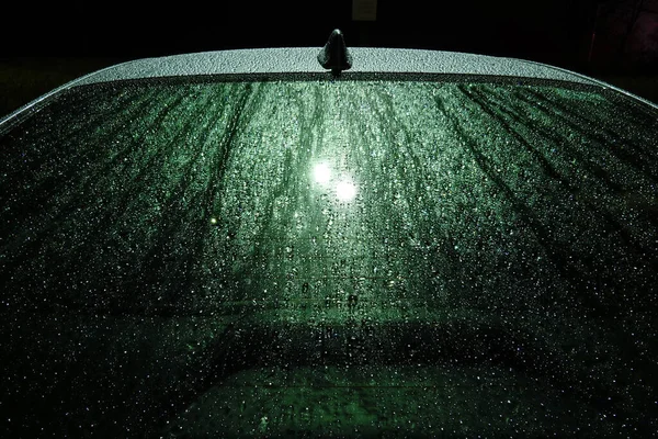 Solomons, Maryland, USA, Raindrops on a car roof and windshield