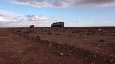 Marsa Matruh, Egypt  Trucks driving in the Sahara desert