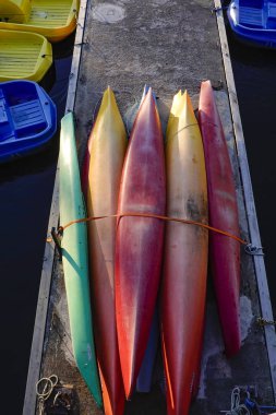 Stockholm, Sweden Colorful canoes  tied up for winter on a dock.