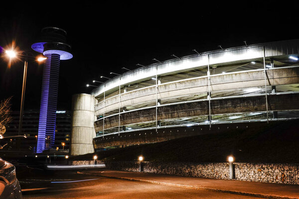 Stockholm, Sweden March 14, 2020 The control tower and a parking garage at night.