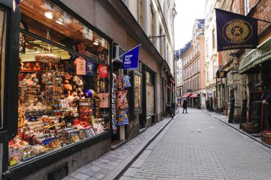 Stockholm, Sweden March 31, 2020 Despite lock downs in all other countries, people in the Swedish capital are still more or less going about their normal business but the streets are noticeably emptier than usual. Pedestrians in the old town clipart