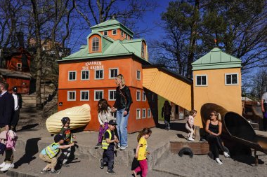 Stockholm, Sweden Children playing a playground in Kvarnholmen during the Corona crisis. The Lilla Kvarnholmen Lekplats or playground is a historical miniature of Kvarnholmen. clipart
