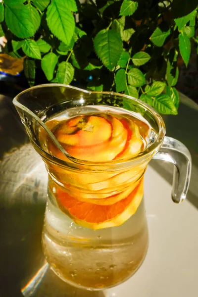 Orange slices in a carafe of water.