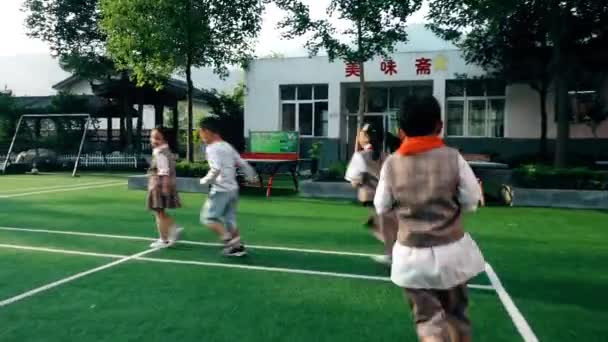Guangyuan, CHINA - JUNE 04, 2019: Schoolchildren running on playground,China. — 비디오