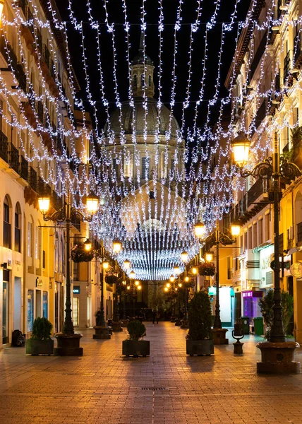 Zaragoza, Spanien / Europa; 11.12.2019: Nachtansicht der Alfonso-Straße mit Weihnachtsbeleuchtung und der Basilika unserer Lieben Frau von der Säule im Hintergrund. Innenstadt von Zaragoza. — Stockfoto