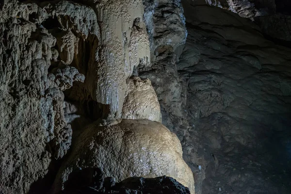 Under the ground. Beautiful view of stalactites and stalagmites in an underground cavern - New Athos Cave. Sacred ancient underworld formations