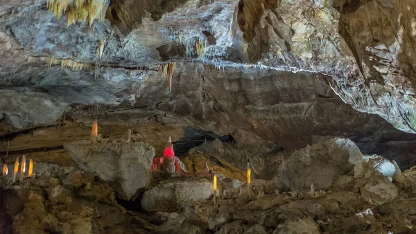 Under the ground. Beautiful view of stalactites and stalagmites in an underground cavern - New Athos Cave. Sacred ancient underworld formations