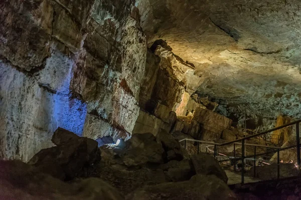 Under the ground. Beautiful view of stalactites and stalagmites in an underground cavern - New Athos Cave. Sacred ancient underworld formations