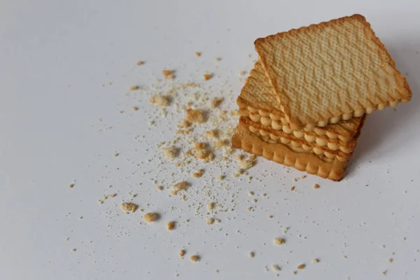Shortbread cookies and crumbs on a white background. Top view cl — Stock Photo, Image
