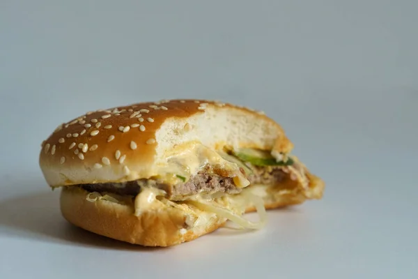 Bitten burger on a white background.