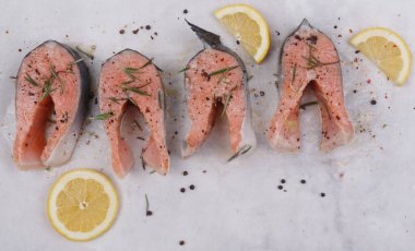 Çiğ somon bifteği, biberiye, limon ve baharat. Yakın plan. Yukarıdan görüntüle.