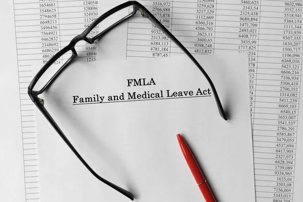 Paper with Family Medical Leave Act FMLA on a table. Business concept