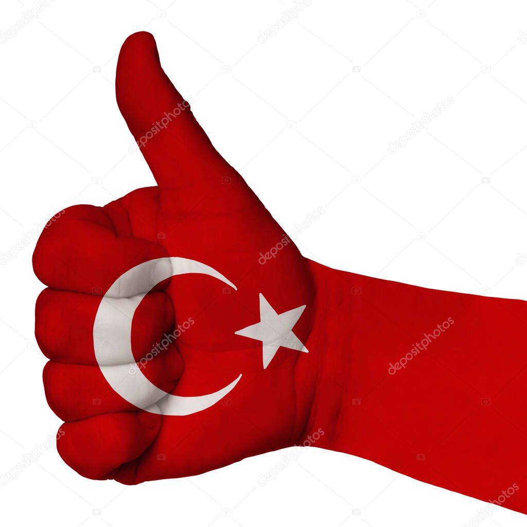 Hand with thumb up gesture in colored turkey national flag as symbol of excellence, achievement, good, - useful for tourism and touristic advertising