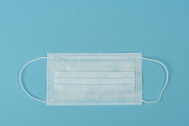 Plastik kulaklıklı cerrahi maske. Ağız ve burnu örtmek için tipik 3 katlı cerrahi maske. Bakterilerin prosedür maskesi. Koruma kavramı.
